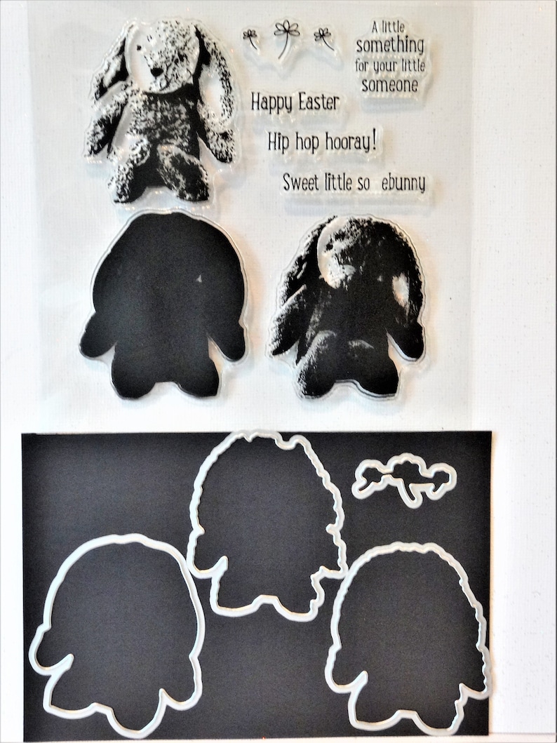 May include: Clear stamp set with a bunny rabbit design. The set includes a large bunny, a smaller bunny, and a flower. The text on the stamp reads "Happy Easter", "A little something for your little someone", "Hip hop hooray!" and "Sweet little so ebunny".