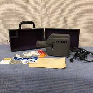 Vintage mid century Skan slide projector with operating manual and original hard carry case.