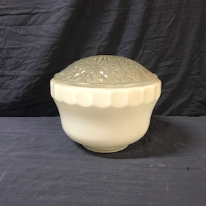 May include: White glass ceiling light fixture with a frosted, patterned dome.