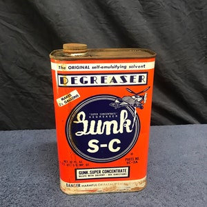 May include: Vintage Gunk S-C degreaser can. The orange can features the text "DEGREASER" and "Gunk S-C" in a blue circle. The can contains 32 fl. oz. and makes 2.5 gallons. The can has a metal cap and is labeled "Danger: Harmful or fatal if swallowed."