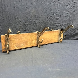 Three vintage coat hooks/ hangers mounted on wood. Vintage hat rack.