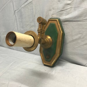 Vintage wall mounted swivel arm light sconce.