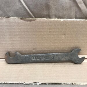 May include: A rusty wrench with the text "MAXWELL - 5" stamped on it.