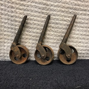 Early turn of the century set of three casters, steel wheels, steel casters.