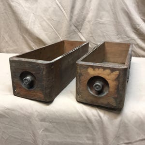 Pair of early century wooden treadle sewing machine drawers.