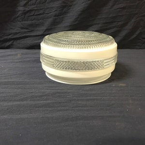 May include: White ceiling light fixture with a clear glass shade featuring a geometric pattern.