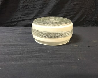 May include: White ceiling light fixture with a clear glass shade featuring a geometric pattern.