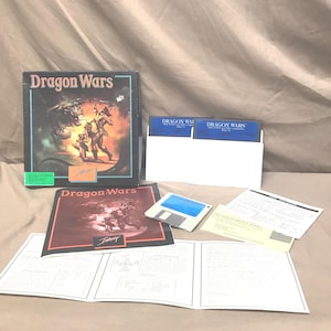 May include: A boxed copy of "Dragon Wars" for the computer, featuring a fantasy illustration of warriors and dragons. Includes floppy disks, manuals, and inserts. The box and materials are in good condition.