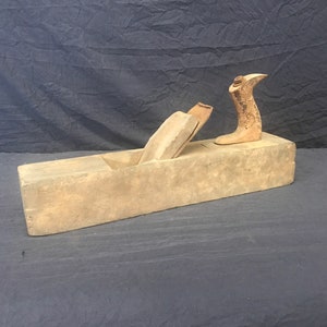 Primitive wood block plane.
