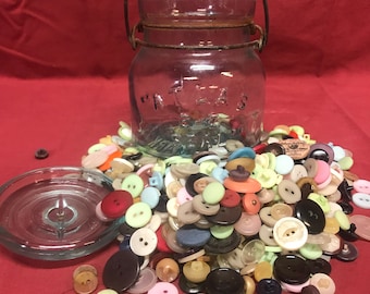 Vintage mini Atlas EZ canning jar filled with buttons.