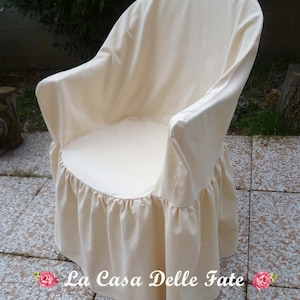May include: A white chair cover with a ruffled bottom. The cover is made of a soft, natural fabric and is designed to protect your chair from dirt and spills. The cover is also easy to remove and wash.