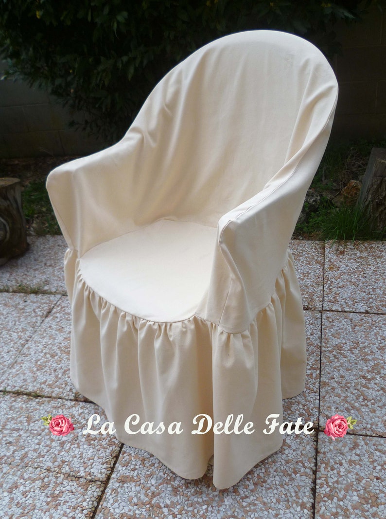 May include: A white chair cover with a ruffled bottom. The cover is made of a soft, natural fabric and is designed to protect your chair from dirt and spills. The cover is also easy to remove and wash.
