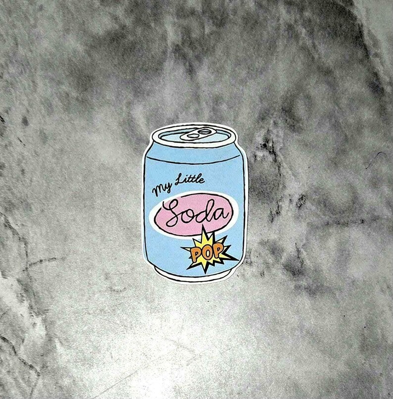 May include: A light blue soda can sticker with the words "My Little Soda" in a pink oval and a yellow "POP" burst graphic. The can has a silver top and is outlined in black.