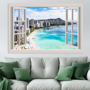 May include: A white framed window with a view of a beach in Hawaii. The beach is lined with palm trees and buildings. The water is a bright turquoise blue.