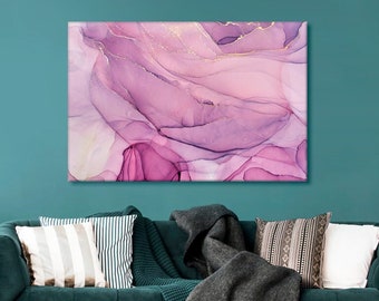 May include: Abstract painting with pink and purple swirls and gold accents. The painting is framed and hanging on a teal wall above a green velvet sofa.