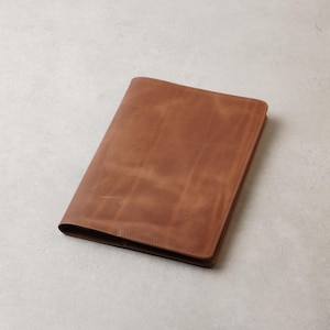 Peut inclure: Une tasse en c&eacute;ramique blanche avec une anse noire et le texte "But First, Coffee" en gras noir. La tasse est pos&eacute;e sur une surface en bois. La tasse mesure environ 10 cm de haut.
