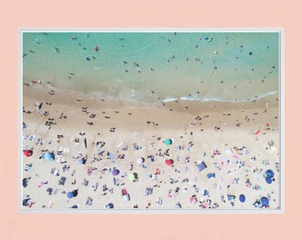 May include: An aerial view of a crowded beach with people sunbathing and swimming in the turquoise water.  The beach is covered with colorful umbrellas and beach towels.