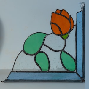 Stained glass corner panel featuring an orange Tulip flower