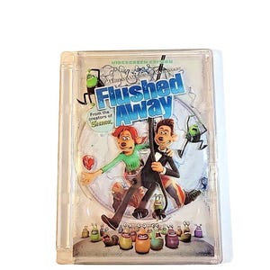 May include: A white ceramic mug with a black handle and the text "But First, Coffee" in a bold, black font. The mug is set against a blurred background, suggesting a cozy setting.