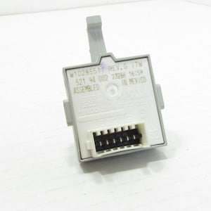 May include: A grey electronic component with a black connector and a grey lever. The component has text that includes "w10285511 REV.G" and "ASSEMBLED IN MEXICO". The component is on a white surface.