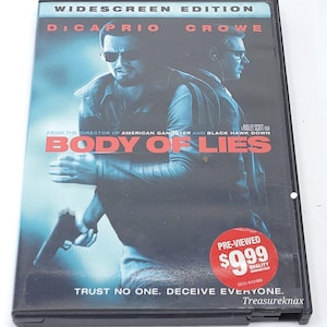 May include: DVD case for the movie "Body of Lies" featuring Leonardo DiCaprio and Russell Crowe. The cover has a dark blue and black color scheme with the title in red. The text "Trust no one. Deceive everyone." is also visible.