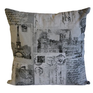 May include: A decorative throw pillow with a gray and white background featuring a vintage Parisian postcard design. The pillow has black and white images of the Eiffel Tower and other Parisian landmarks.