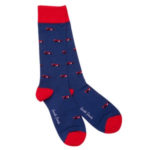 May include: A pair of blue socks with a red and white race car pattern. The socks have a red cuff and the words "Swanky Panda" are printed on the side.