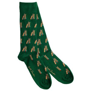 May include: A pair of green socks with a repeating pattern of cricket bats and wickets. The socks have a dark green background with tan, red, and teal accents on the cricket equipment. The brand name "Smile Panda" is printed on the socks.