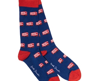 May include: A pair of blue socks with a red heel, toe, and cuff. The socks are patterned with red double-decker buses. The text "Swale Paradis" is printed in white on the side of each sock.