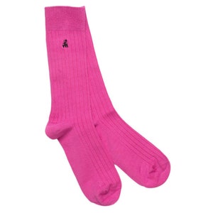 May include: A pair of pink ribbed socks with a small black logo on the front.