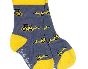 May include: A pair of blue and yellow toddler socks with a pattern of yellow construction vehicles. The socks have a yellow cuff and the words "Kids Socks" are printed on the bottom of one sock.