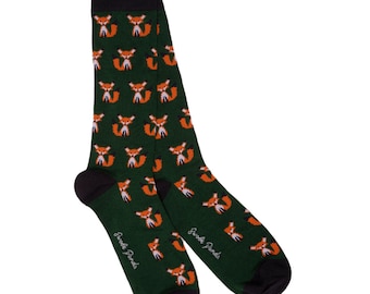 May include: A pair of green socks with a repeating pattern of orange foxes. The socks have black cuffs and the words "Scoot Pants" are printed on the side.