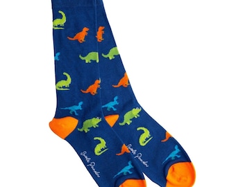 May include: A pair of blue socks with an orange heel and toe, patterned with colorful dinosaur illustrations. The socks feature green, orange, and blue dinosaurs. The text "Simple Paradise" is printed on the side of each sock.