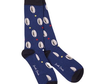 May include: A pair of blue socks with a white rugby ball pattern. The socks have a black cuff and a red and yellow dot pattern.