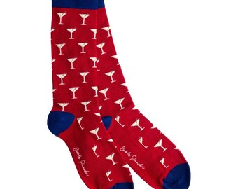 May include: A pair of red socks with a pattern of white martini glasses. The socks have blue heels and cuffs. The text "Smile Paradise" is printed on the side of each sock.