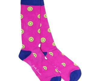 May include: A pair of bright pink socks with a pattern of green kiwi slices. The socks have blue heels and cuffs. The text "Smile Provider" is printed on the side of each sock.