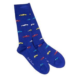 May include: A pair of blue socks with a pattern of colorful cars in red, yellow, white, and blue. The socks have the text "Emile Pander" printed on the side.