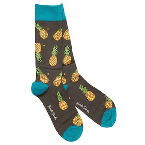 May include: A pair of dark gray socks with a pineapple pattern. The socks have a turquoise blue cuff and heel. The socks are made by "Sweet Panda".