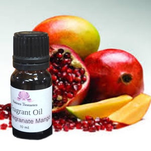 May include: A small brown glass bottle with a black cap and a white label that reads "Natures Treasures Fragrant Oil Pomegranate Mango 10 ml". The bottle is in front of a red pomegranate, a yellow mango, and a red mango.