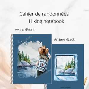May include: A blue hiking notebook with a watercolour illustration of a hiker in a forest on the front cover and a watercolour illustration of a forest scene in a photo frame on the back cover. The notebook has a spiral binding and the text "Caher de randonnées Hiking notebook" is printed on the front cover.