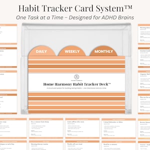 May include: A clear plastic box containing a Home Harmony Habit Tracker Deck. The deck includes cards for daily, weekly, and monthly tasks. The text on the box reads "Habit Tracker Card System" and "One Task at a Time - Designed for ADHD Brains."