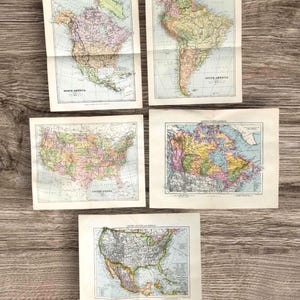May include: Five vintage paper maps featuring North America, South America, the United States, Canada, and a combined map of the United States and Mexico. Each map displays colorful political boundaries, geographic details, and printed labels.