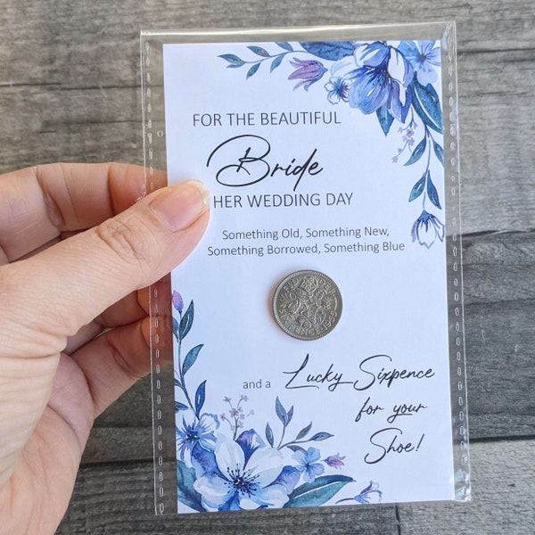 A wedding lucky six pence mounted on a card for the bride on her wedding day to place in her shoe.