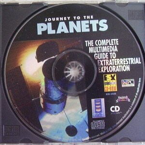 May include: A black CD-ROM disc in a clear plastic case. The disc features the text "JOURNEY TO THE PLANETS" in white and blue, along with "THE COMPLETE MULTIMEDIA GUIDE TO EXTRATERRESTRIAL EXPLORATION." A colorful graphic of a spacecraft is also visible.