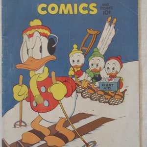 May include: A vintage Walt Disney's Comics magazine cover featuring Donald Duck skiing with three nephews. Donald is wearing a red jacket, yellow scarf, and a white hat. The nephews are wearing winter gear and carrying a first aid kit.