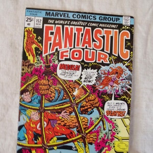 May include: A vintage comic book cover featuring the Fantastic Four. The cover is yellow with red and black lettering. The title "Fantastic Four" is in large, bold letters. The characters are in a cage-like structure with a pink and purple background. The text on the cover reads "World of Madness... World of Doom!"