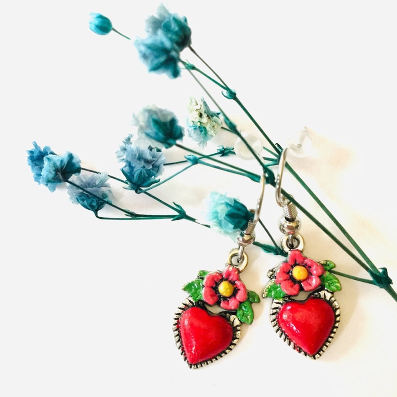 Hand Painted Mexican silver red heart earrings with pink flower and green leaves painted by hand with enamel painte. Drop-dangling heart earrings for women and girls. Frida earrings. Mexico folk art corazon aretes para mujer. Cute original gift idea.