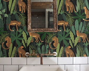 May include: A bathroom with a white sink, brass fixtures, and a gold-framed mirror. The wallpaper features a black background with a jungle design and orange leopards. White subway tiles line the wall above the sink.