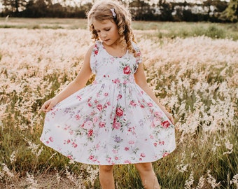 Robe d'été blanche en coton fleuri pour fille avec manches flottantes. Parfait pour une fête d'anniversaire, un mariage, une fleuriste