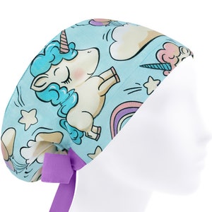 May include: A light blue surgical scrub hat with a unicorn, rainbow, and star pattern. The hat has a purple tie.